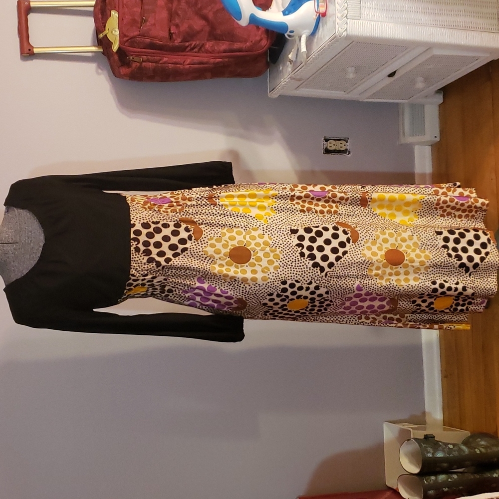 Vintage dress. Black on top   Cinched waste. Multicolor flowers on bottom.